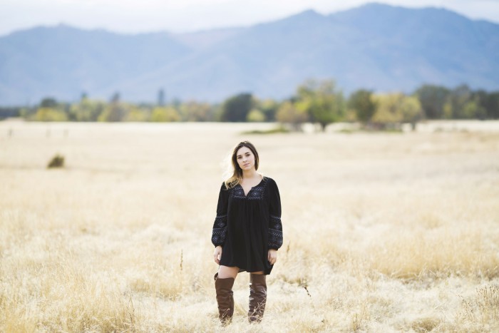 Senior photo pose in brown grass