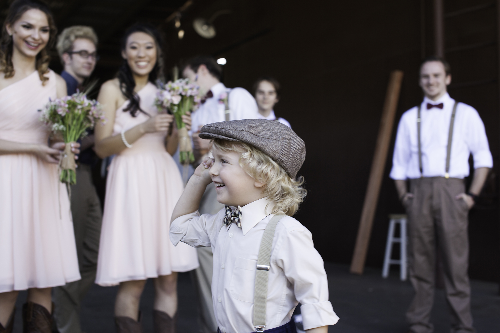 Ring bearer cracking up the wedding party